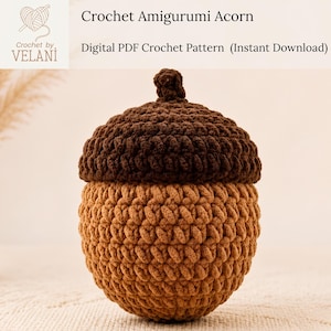 May include: A crochet amigurumi acorn featuring a dark brown textured cap and a light brown rounded base. The text Crochet by VELANI, Crochet Amigurumi Acorn, and Digital PDF Crochet Pattern (Instant Download) is visible at the top of the image.