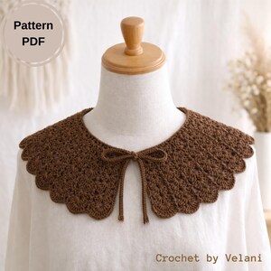 May include: A brown crochet collar with a scalloped edge and a bow tie closure. The collar is displayed on a mannequin and is labeled "Pattern PDF" and "Crochet by Velani". The collar is a handmade accessory.