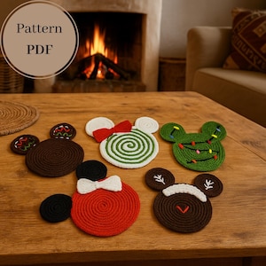May include: A collection of handmade coasters in the shape of a mouse. The coasters are made of brown, red, white, and green rope. Some coasters have bowties, while others have decorative elements. The text "Pattern PDF" is in a circle in the upper left.
