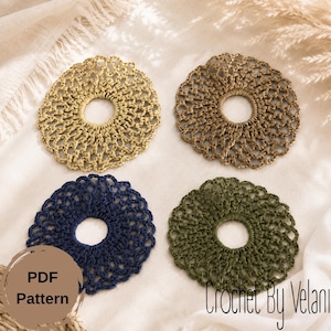 May include: Four circular crochet coasters in light yellow, tan, navy blue, and olive green. Each coaster features a central circular opening and a delicate, openwork scalloped edge pattern. A circular brown badge displays the text PDF Pattern.