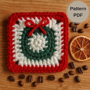 May include: A square, crocheted coaster with a red border, white and green center, and a small red bow. The coaster is surrounded by coffee beans and a dried orange slice. The text "Pattern PDF" is in a circle in the upper right corner.