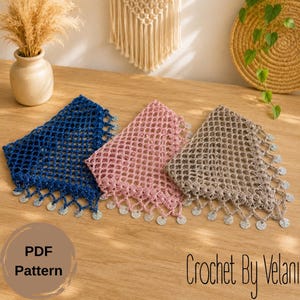May include: Three crocheted square doilies in blue, pink, and tan, each with a fringe of silver sequins. The doilies are displayed on a wooden surface. Text on the image reads "PDF Pattern" and "Crochet By Velani".