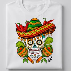 May include: White t-shirt featuring a colorful sugar skull design. The skull wears a sombrero and is surrounded by maracas, chili peppers, and cacti. The design incorporates vibrant colors and intricate details, perfect for celebrating Mexican culture.