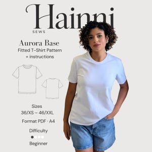 Puede incluir: Una camiseta blanca de manga corta usada con pantalones cortos de mezclilla azul. La imagen incluye texto: Hainni Sews, Aurora Base Fitted T-Shirt Pattern + instructions, Sizes 36/XS – 46/XXL, Format PDF · A4, y Difficulty Beginner con tres puntos.