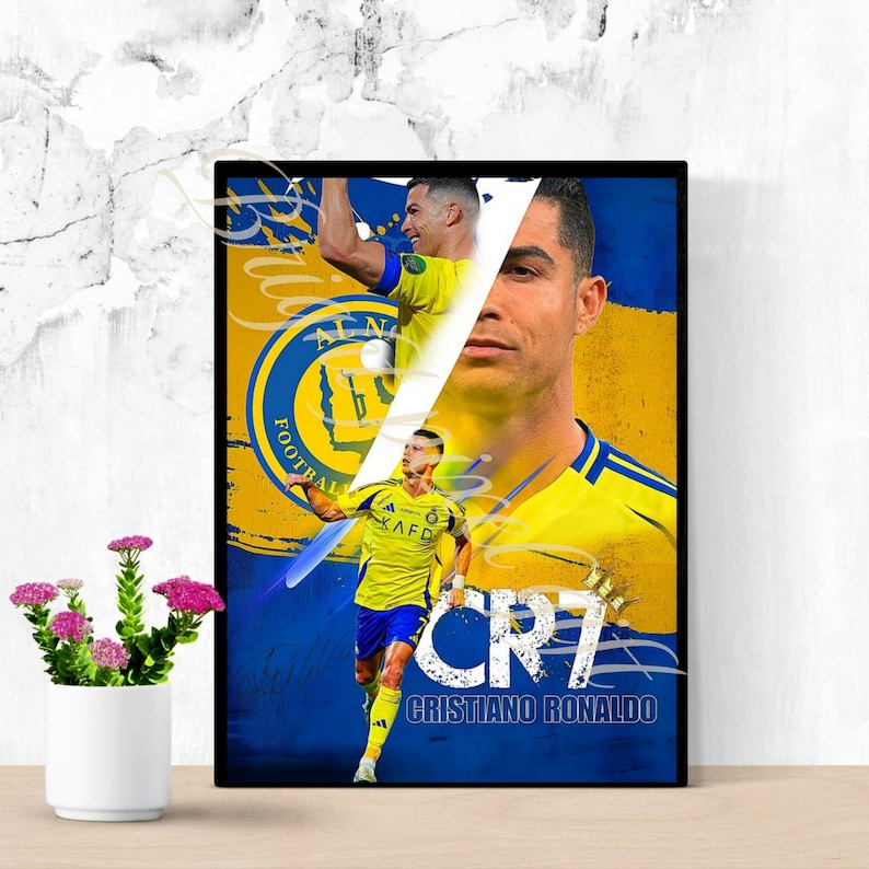 May include: Framed poster featuring Cristiano Ronaldo in a yellow and blue soccer uniform. The poster includes multiple images of Ronaldo, the text "CR7" and "Cristiano Ronaldo" in white, set against a yellow and blue background.