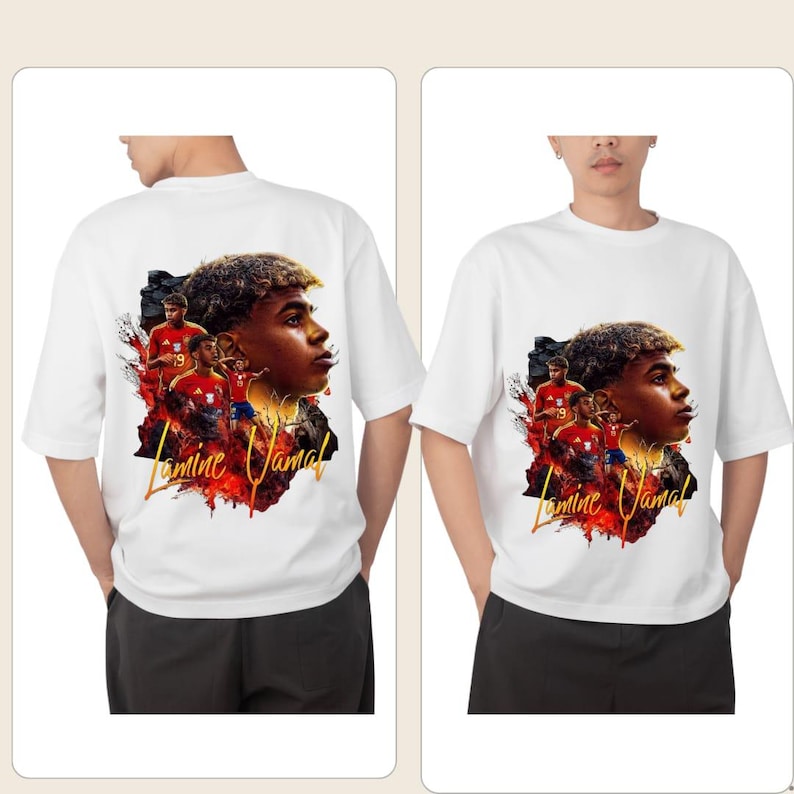 May include: White t-shirt with a graphic of a soccer player and the text "Lamine Jamal". The design incorporates images of players in red kits and a fiery backdrop. The shirt has short sleeves.