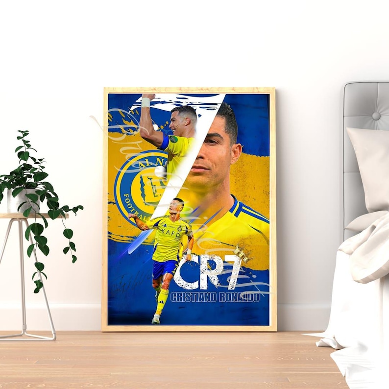 May include: Framed poster featuring Cristiano Ronaldo in a yellow and blue soccer uniform. The poster has a split design with Ronaldo's face on the right and action shots on the left. The text "CR7" and "Cristiano Ronaldo" are visible.