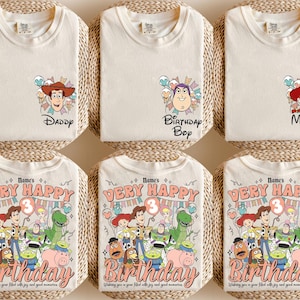 May include: Cream-colored t-shirts with cartoon character graphics and text. One shirt says "Daddy", another "Birthday Boy", and a third "Mommy". The bottom shirts feature a colorful graphic with the text "Very Happy Birthday".