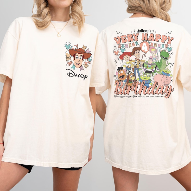 May include: Cream-colored t-shirt featuring a cartoon image of Woody from Toy Story with the word "DADDY" below. The back of the shirt displays a colorful birthday design with the text "Anthony's Very Happy 4th Birthday".