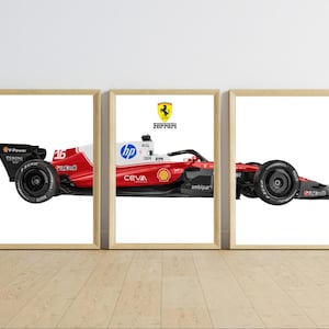 May include: A triptych of three framed prints displaying a red and white Formula 1 race car. The car features the Ferrari logo, the number 16, and various sponsor decals including HP, Shell, and Ceva. The car is shown in profile across three panels.