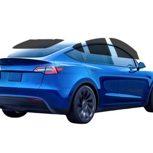 May include: A blue electric SUV with tinted windows, seen from the rear three-quarter angle. The vehicle has black wheels and a spoiler. The background is plain white.
