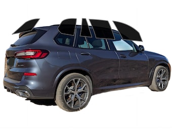 May include: Dark gray SUV with tinted windows. The vehicle has black rims and a rear spoiler. The taillights are red. The car is set against a white background.