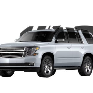 May include: A silver SUV with tinted windows. The vehicle has a chrome grill, black tires, and a black front bumper. The windows are shown with various tint levels, demonstrating the product's features.