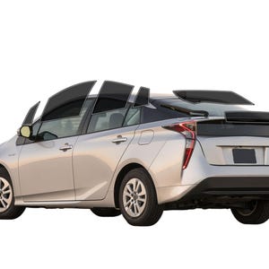 May include: Silver hybrid car with tinted windows and a rear spoiler. The car has black tires and rims. The taillights are red. The car is set against a white background.