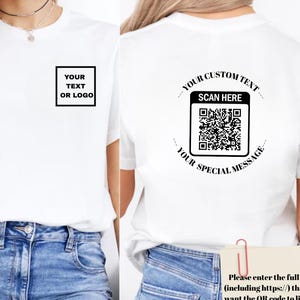 May include: White t-shirt with a square design on the front that says "YOUR TEXT OR LOGO". The back of the shirt has a QR code with the text "YOUR CUSTOM TEXT SCAN HERE YOUR SPECIAL MESSAGE".
