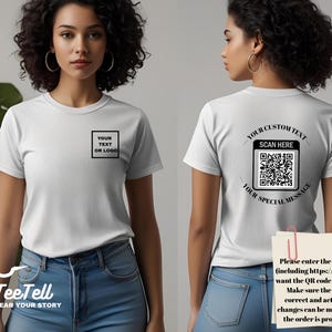 May include: White t-shirt with a square graphic on the front that says "YOUR TEXT OR LOGO". The back of the shirt has a QR code with the text "YOUR CUSTOM TEXT SCAN HERE YOUR SPECIAL MESSAGE".