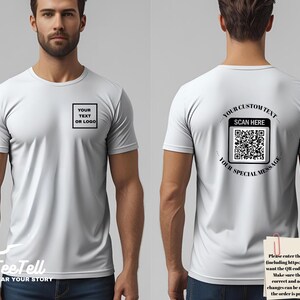 May include: White t-shirt with short sleeves. The front of the shirt has a black square with the text "YOUR TEXT OR LOGO". The back of the shirt has a QR code with the text "YOUR CUSTOM TEXT", "SCAN HERE", and "YOUR SPECIAL MESSAGE".