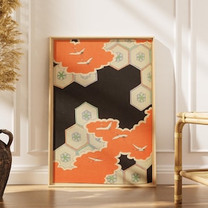 Puede incluir: Lámina enmarcada con un diseño de inspiración japonesa. La obra presenta un fondo negro con formas de nubes naranjas y patrones geométricos. Aves blancas vuelan por la escena. La impresión está en un marco de madera marrón claro.