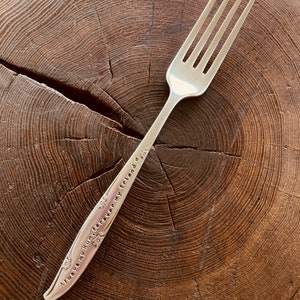 May include: Silver fork with a floral design and the inscription "Always in my heart, forever my friend".