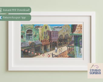 May include: A framed cross-stitch depicting a colorful street scene with buildings in shades of green, yellow, and purple. The image includes people walking on the street and hanging lanterns. The frame is white. Text on the image says "Instant PDF Download!" and "Pattern Keeper App."