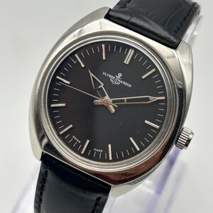 intage Ulysse Nardin manual wind watch with black dial and leather strap