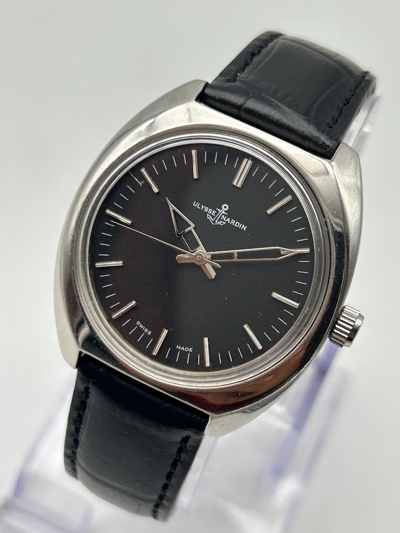 intage Ulysse Nardin manual wind watch with black dial and leather strap