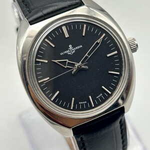 intage Ulysse Nardin manual wind watch with black dial and leather strap