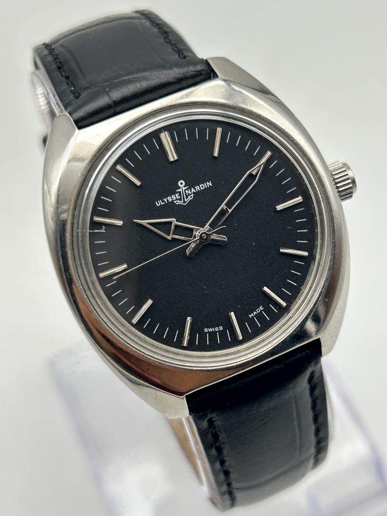 intage Ulysse Nardin manual wind watch with black dial and leather strap