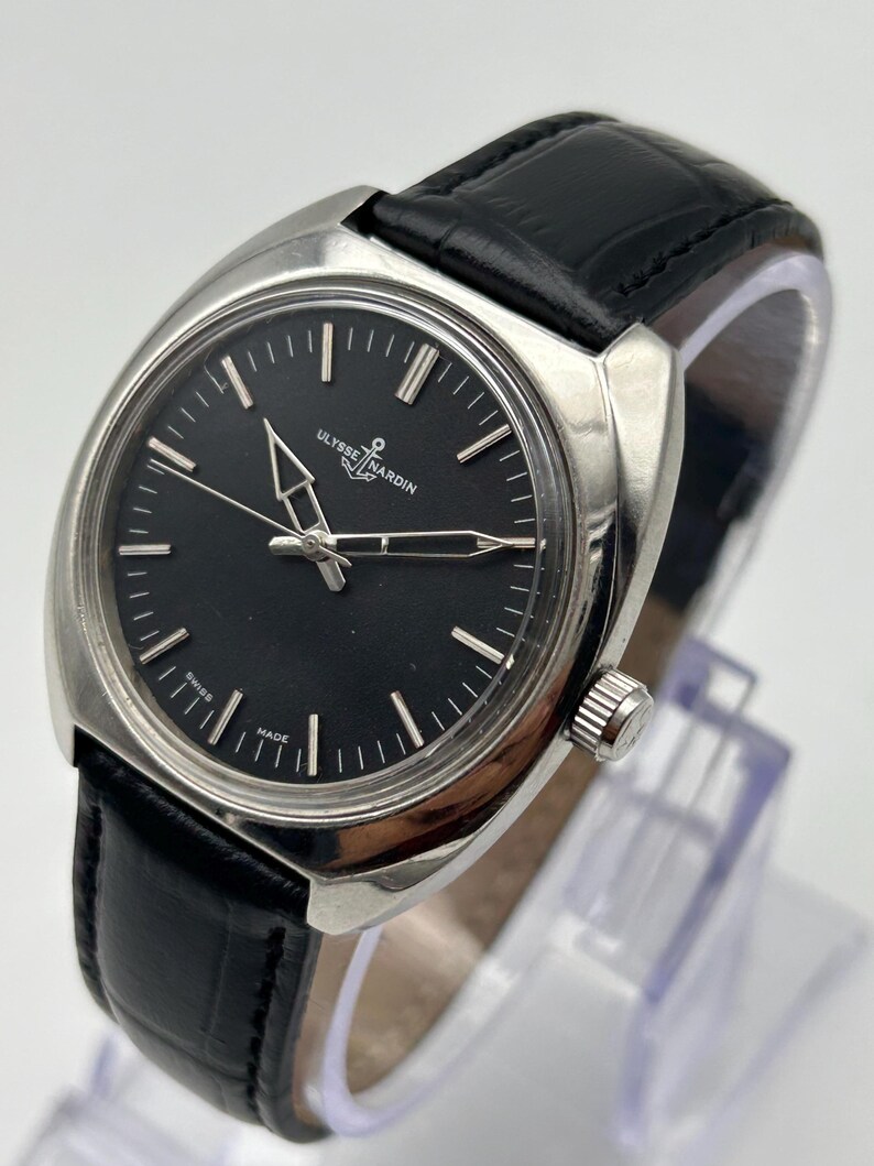 intage Ulysse Nardin manual wind watch with black dial and leather strap