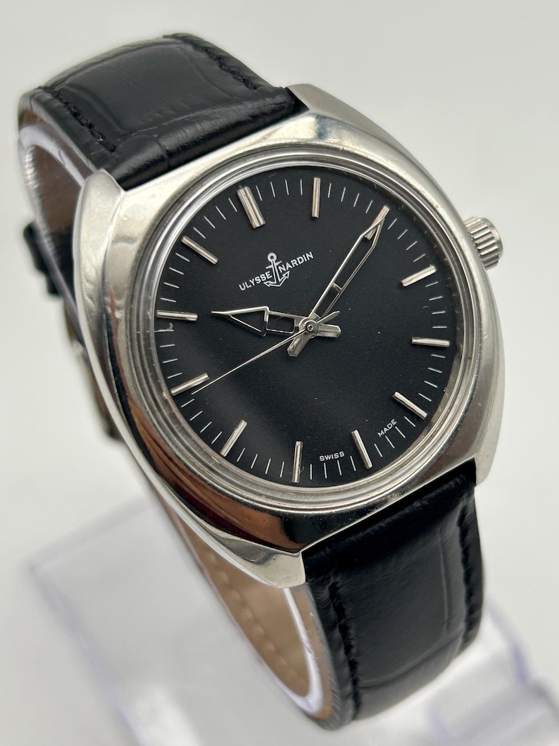intage Ulysse Nardin manual wind watch with black dial and leather strap
