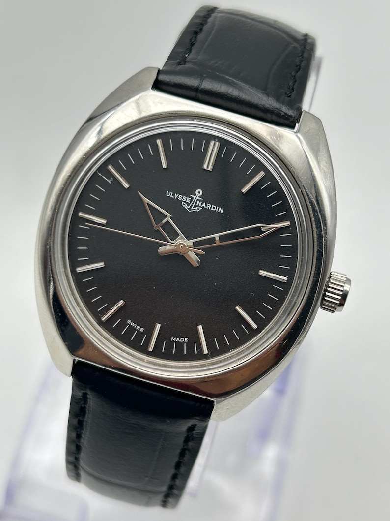 intage Ulysse Nardin manual wind watch with black dial and leather strap