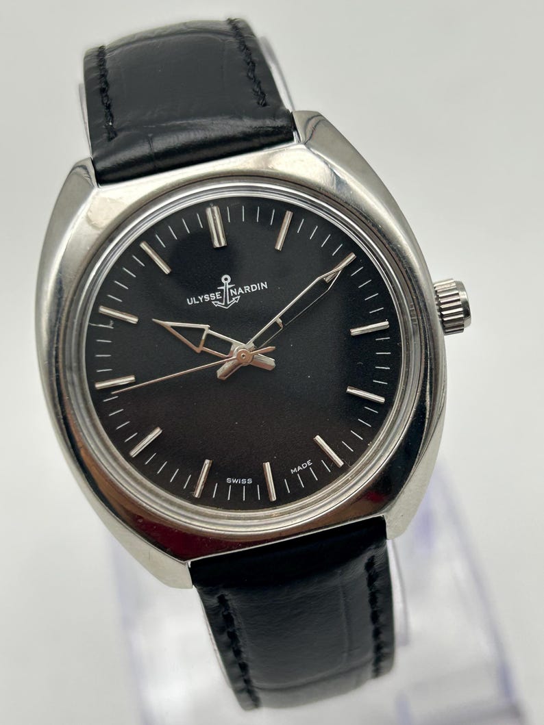 intage Ulysse Nardin manual wind watch with black dial and leather strap