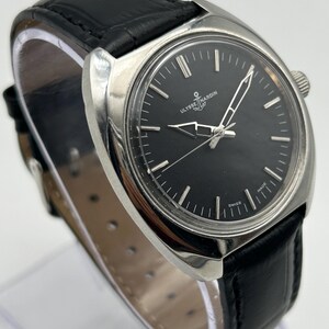 intage Ulysse Nardin manual wind watch with black dial and leather strap