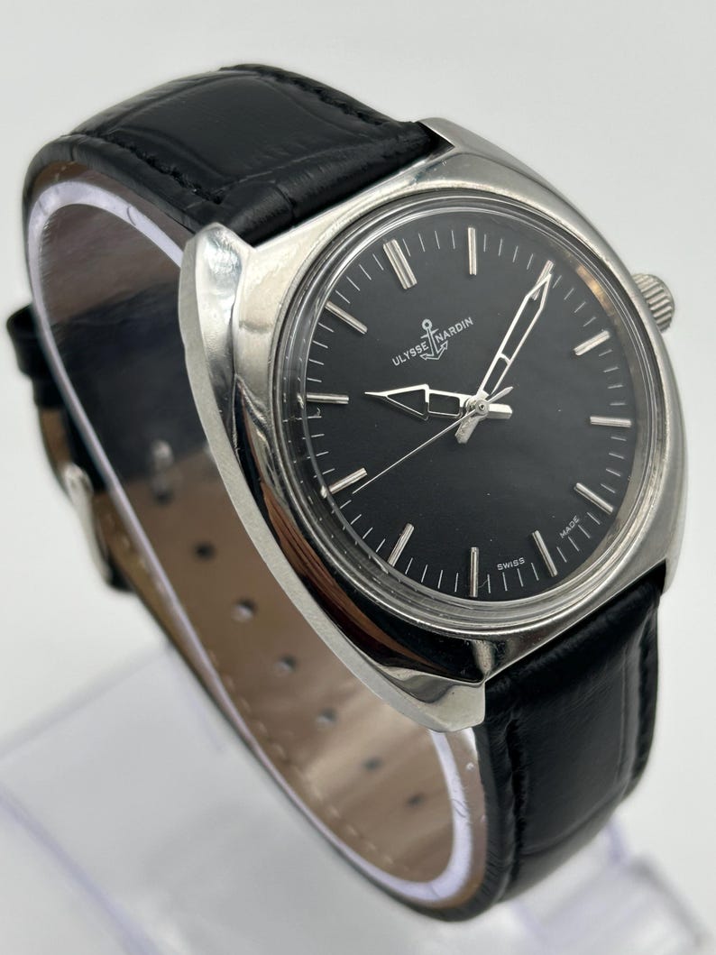 intage Ulysse Nardin manual wind watch with black dial and leather strap