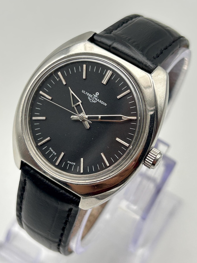 intage Ulysse Nardin manual wind watch with black dial and leather strap