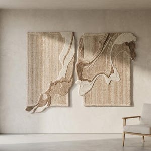 May include: Two abstract wall hangings with beige and brown swirling patterns. The rectangular pieces are mounted on a neutral-colored wall. A wooden cabinet, a chair, and a floor lamp are in the room.