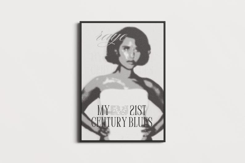 May include: Black and white framed print featuring a stylized image of a person with the text "raye" at the top. The text "MY 21ST CENTURY BLUES" is centered below the person's image.