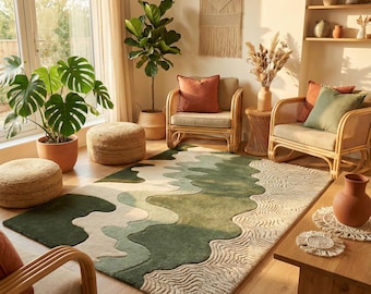 May include: A living room scene featuring a large, green and beige patterned rug. Two rattan armchairs with orange and green cushions are arranged around the rug. Potted plants and decorative items complete the cozy, inviting space.