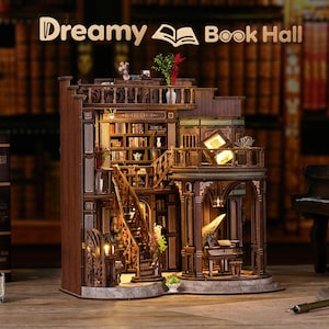 May include: A detailed wooden miniature of a library, featuring multiple levels, staircases, and bookshelves filled with tiny books. The model has warm lighting, creating a cozy atmosphere. The text "Dreamy Book Hall" is displayed at the top.