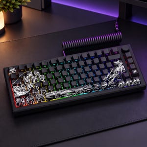 May include: A black mechanical keyboard featuring custom keycaps with white line art illustrations of waves and mountains. The keyboard has RGB backlighting, a coiled black cable, and a circular knob on the top right corner of the chassis.