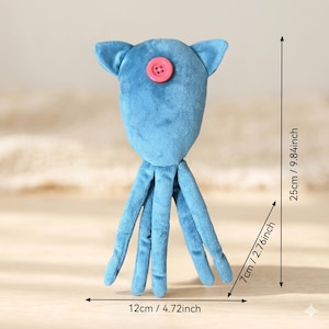 May include: A blue plush toy shaped like a squid with a pink button centered on its head. The toy measures 9.84 inches in total height, 2.76 inches in width, and 4.72 inches in base width, as indicated by the visible measurement lines.