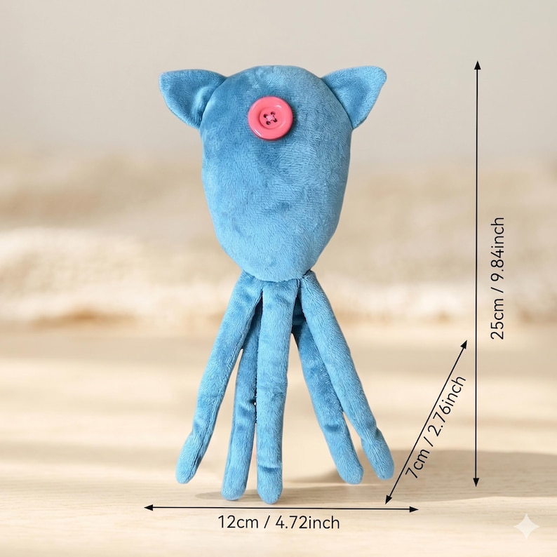 May include: A blue plush toy shaped like a squid with a pink button centered on its head. The toy measures 9.84 inches in total height, 2.76 inches in width, and 4.72 inches in base width, as indicated by the visible measurement lines.
