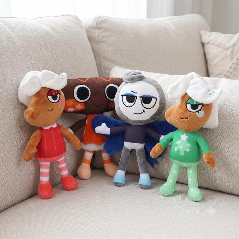 May include: Four plush dolls featuring cartoon characters. Two dolls have brown skin, white hair, and festive outfits. One doll is brown with large circular eyes and orange accents. One doll is gray with blue wings, a dark blue shirt, and light blue boots.