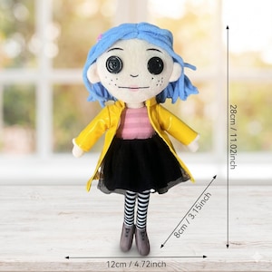 May include: A plush doll with blue yarn hair, button eyes, and freckles. It wears a yellow raincoat, a pink striped shirt, a black skirt, and black and white striped leggings. The doll measures 28 cm (11.02 inches) tall, 12 cm wide, and 8 cm deep.