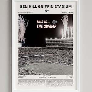 May include: Framed black and white print of Ben Hill Griffin Stadium, also known as The Swamp, home of the Florida Gators. The print includes the text "THIS IS... THE SWAMP" and stadium details. The stadium opened in 1930 and has a capacity of 80,548.