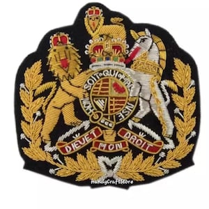 May include: Embroidered patch featuring a royal crest with a lion, unicorn, crown, and banner with text. The patch is black with gold, red, and white detailing. The text "DIEU ET MON DROIT" is visible.