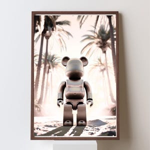 May include: A framed print featuring a metallic bear-shaped figure standing in front of a blurred background of palm trees. The figure has a smooth, reflective surface and is positioned centrally within the frame. The frame is a dark brown color.