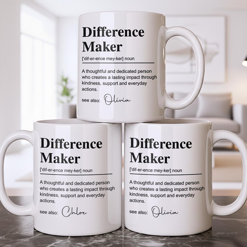 May include: Three white ceramic mugs featuring black text that defines the term Difference Maker as a thoughtful and dedicated person who creates a lasting impact through kindness, support and everyday actions, with the names Olivia and Chloe.