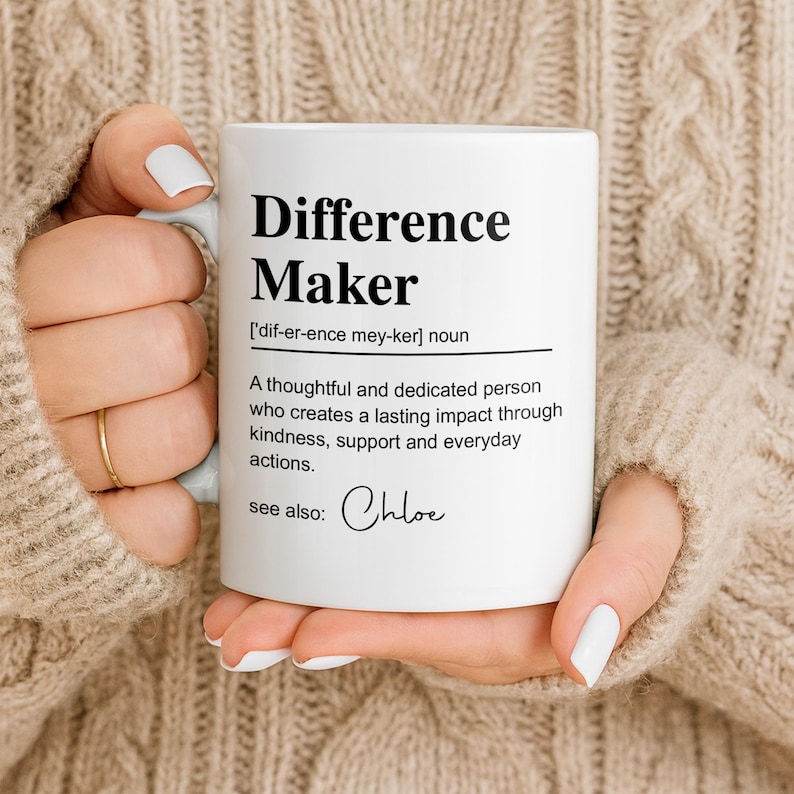 May include: A white ceramic mug featuring black printed text that defines the term Difference Maker as a thoughtful and dedicated person who creates a lasting impact through kindness, support and everyday actions, with the name Chloe listed below.