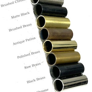 May include: An assortment of cylindrical metal tubes in various finishes, including brushed chrome, matte black, brushed brass, antique patina, polished brass, raw brass, black brass, and polished chrome. The names of the finishes are printed in black text.